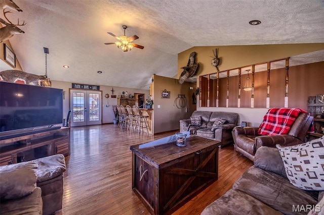 10530 Aspen Rd, Conway, MO 65632 - living area featuring vaulted ceiling, wood finished floors, ceiling fan, a textured ceiling, and french doors