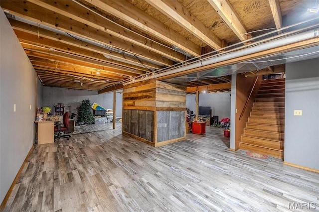 10530 Aspen Rd, Conway, MO 65632 - unfinished below grade area with wood finished floors, stairway, a desk, and baseboards