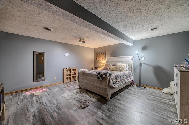 10530 Aspen Rd, Conway, MO 65632 - bedroom featuring a textured ceiling, baseboards, and wood finished floors
