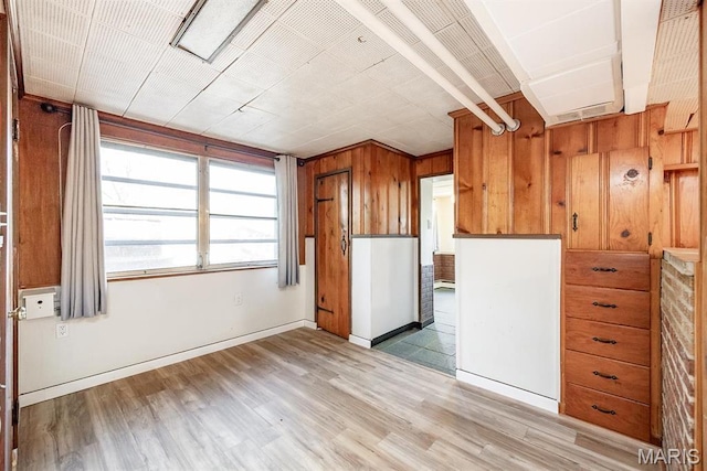 10 Hill Dr, Fairview Heights, IL 62208 - kitchen with light wood-type flooring, brown cabinets, and wooden walls