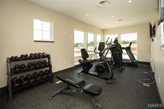 exercise area with recessed lighting and baseboards
