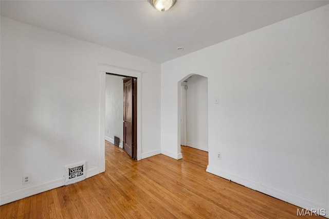 5923 Sherry Ave, Saint Louis, MO 63136 - unfurnished room with arched walkways, baseboards, and light wood-style floors