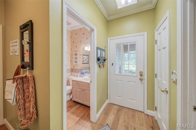 doorway to outside featuring light wood-type flooring and ornamental molding