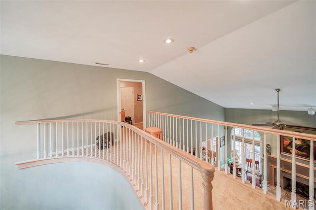 corridor with carpet floors, recessed lighting, and vaulted ceiling