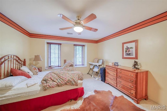 bedroom featuring carpet, ornamental molding, and ceiling fan