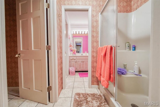 full bathroom featuring wallpapered walls, a shower stall, tile patterned floors, and vanity