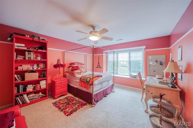 carpeted bedroom featuring baseboards, a desk, and ceiling fan