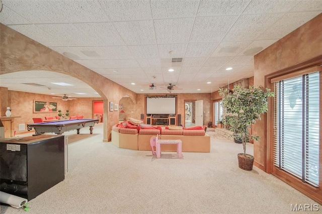 carpeted living area featuring a ceiling fan, billiards table, arched walkways, a paneled ceiling, and recessed lighting