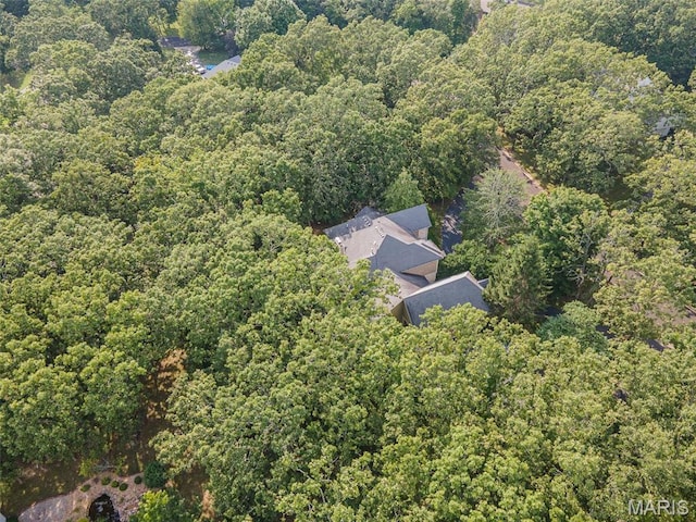view from above of property with a heavily wooded area