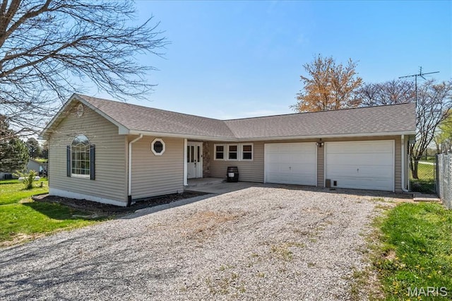 6639 Gladel Dr, Waterloo, IL 62298 - ranch-style house featuring gravel driveway, a garage, and roof with shingles