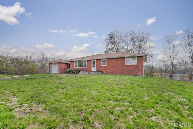 1219 N Park St, Hardin, IL 62047 - view of front facade with brick siding, an attached garage, and a front lawn