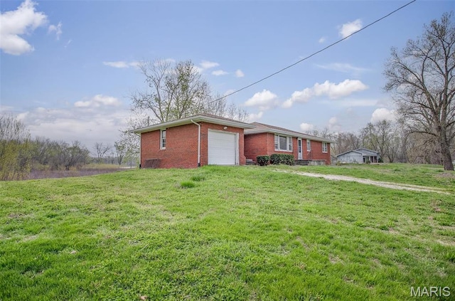 1219 N Park St, Hardin, IL 62047 - view of side of home with brick siding, a garage, and a lawn