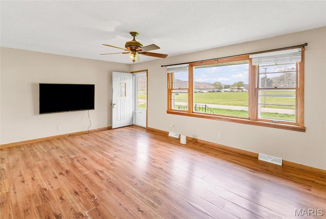 1219 N Park St, Hardin, IL 62047 - unfurnished living room featuring light wood-style floors, a ceiling fan, and baseboards