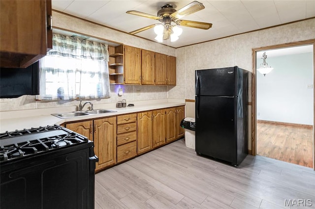1219 N Park St, Hardin, IL 62047 - kitchen featuring black appliances, brown cabinetry, a sink, light countertops, and a ceiling fan