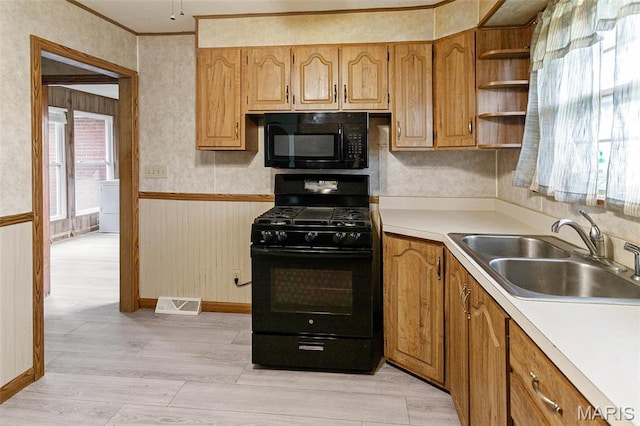 1219 N Park St, Hardin, IL 62047 - kitchen with black appliances, a sink, light wood-type flooring, light countertops, and open shelves