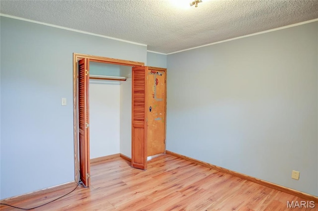 1219 N Park St, Hardin, IL 62047 - unfurnished bedroom featuring light wood finished floors, a closet, crown molding, a textured ceiling, and baseboards