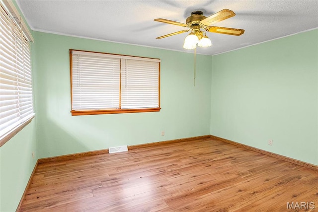 1219 N Park St, Hardin, IL 62047 - empty room featuring wood finished floors, ceiling fan, baseboards, and ornamental molding