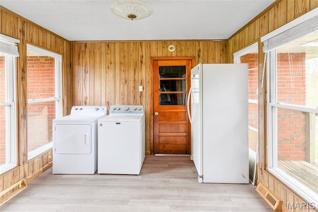 1219 N Park St, Hardin, IL 62047 - laundry area featuring wooden walls, separate washer and dryer, and light wood-style flooring