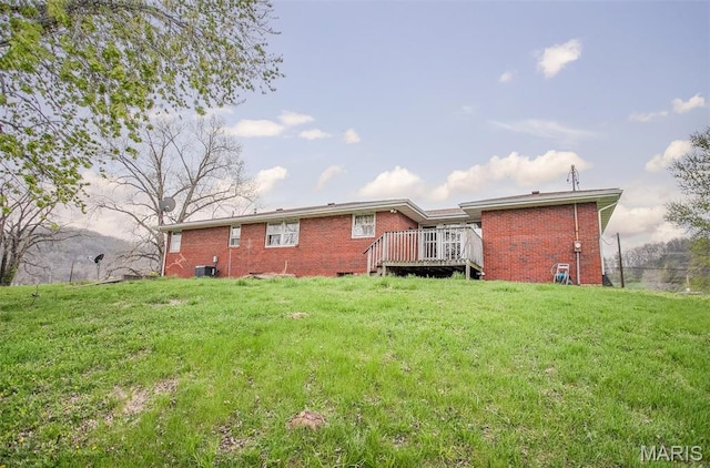 1219 N Park St, Hardin, IL 62047 - back of house with a lawn, a wooden deck, and brick siding