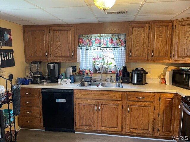 101 County Road 5170, Salem, MO 65560 - kitchen with black appliances, a sink, a drop ceiling, brown cabinetry, and light countertops