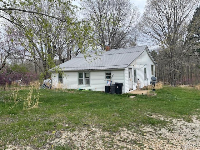 101 County Road 5170, Salem, MO 65560 - view of property exterior with a chimney, metal roof, and a lawn