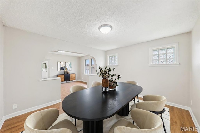241 Dammert Ave, Saint Louis, MO 63125 - dining space with wood finished floors, baseboards, and a textured ceiling