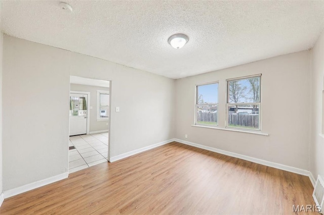 241 Dammert Ave, Saint Louis, MO 63125 - unfurnished room with wood finished floors, a textured ceiling, baseboards, and a smoke detector