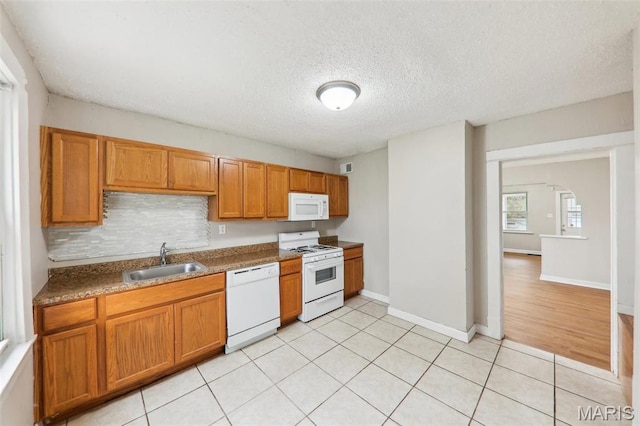 241 Dammert Ave, Saint Louis, MO 63125 - kitchen with white appliances, a sink, brown cabinets, tasteful backsplash, and a textured ceiling