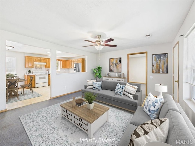 710 W Jefferson Ave, Conway, MO 65632 - living area with a ceiling fan, baseboards, and light carpet