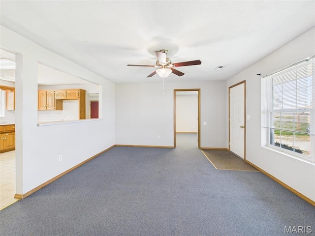 710 W Jefferson Ave, Conway, MO 65632 - unfurnished room with a ceiling fan, baseboards, and light carpet