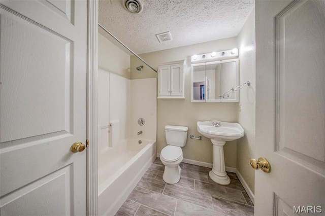 full bathroom with toilet, baseboards, washtub / shower combination, and a textured ceiling