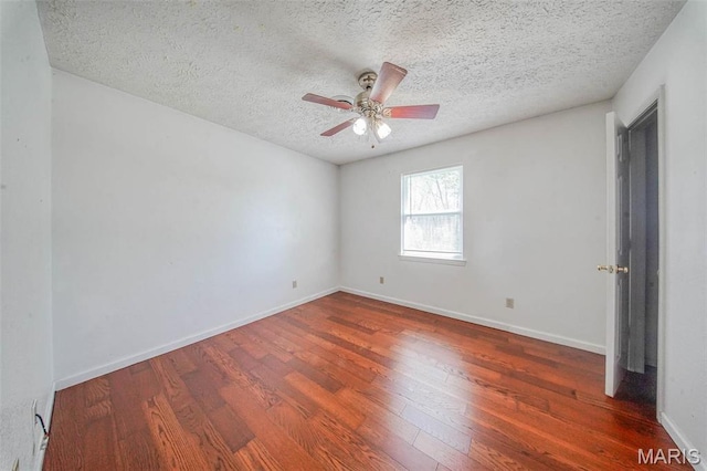 unfurnished room featuring wood finished floors, a textured ceiling, ceiling fan, and baseboards