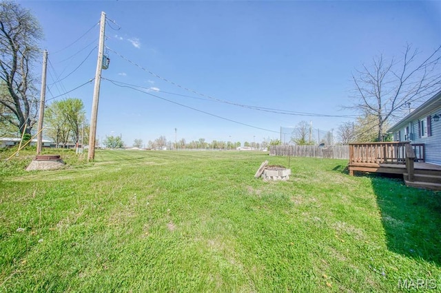 view of grassy yard with a deck