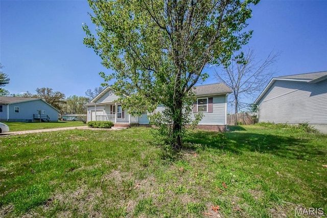 view of front of home featuring covered porch and a front lawn