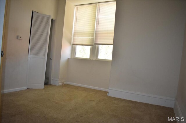 2912 Indiana Ave, Saint Louis, MO 63118 - unfurnished bedroom featuring carpet floors and baseboards