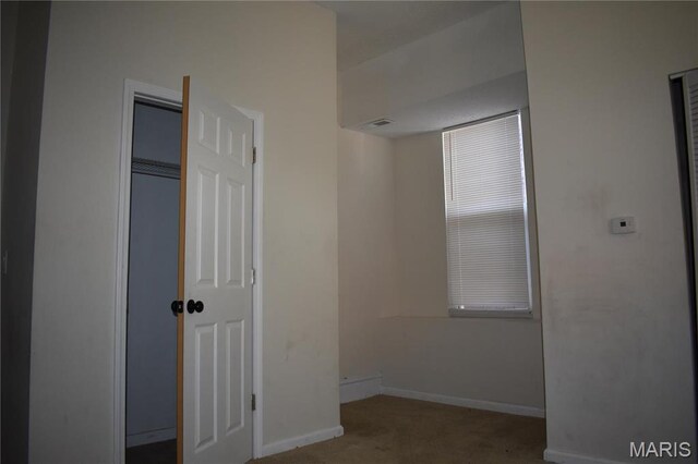 2912 Indiana Ave, Saint Louis, MO 63118 - unfurnished bedroom featuring carpet, baseboards, and a closet