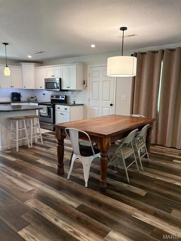 10817 Cabin Ln, Dexter, MO 63841 - dining space with dark wood-style flooring and recessed lighting