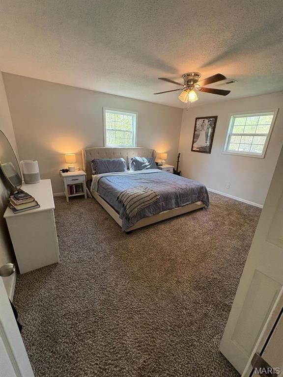 10817 Cabin Ln, Dexter, MO 63841 - bedroom with a textured ceiling, dark colored carpet, ceiling fan, and baseboards