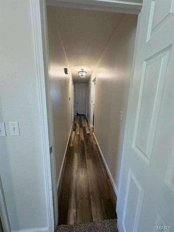 10817 Cabin Ln, Dexter, MO 63841 - hallway with baseboards, dark wood finished floors, and a textured ceiling