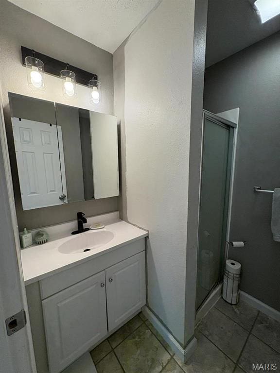10817 Cabin Ln, Dexter, MO 63841 - full bath with a shower stall, vanity, baseboards, and tile patterned flooring
