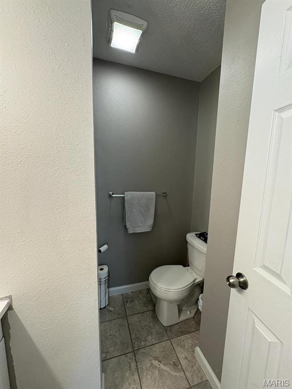 10817 Cabin Ln, Dexter, MO 63841 - bathroom featuring toilet, tile patterned flooring, a textured ceiling, baseboards, and vanity