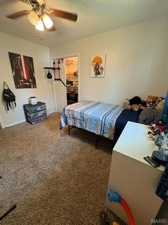 10817 Cabin Ln, Dexter, MO 63841 - carpeted bedroom featuring ceiling fan, a textured ceiling, and baseboards