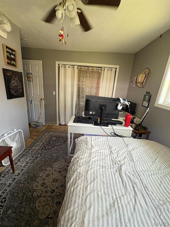 10817 Cabin Ln, Dexter, MO 63841 - bedroom with wood finished floors, a textured ceiling, and ceiling fan