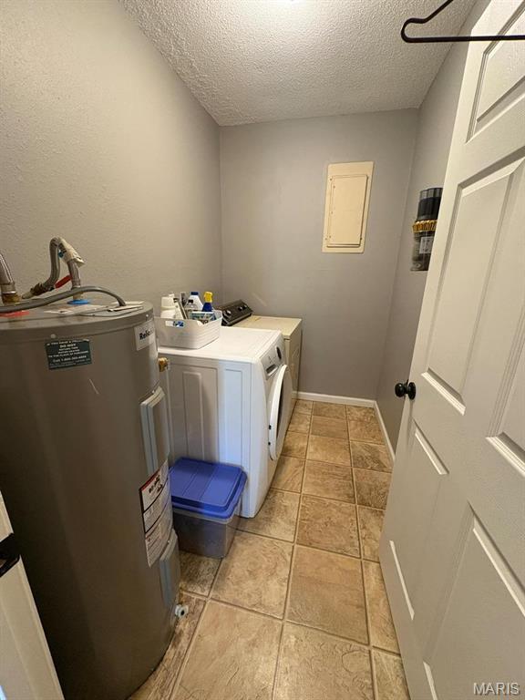 10817 Cabin Ln, Dexter, MO 63841 - laundry room with water heater, a textured ceiling, washer and dryer, and light tile patterned flooring