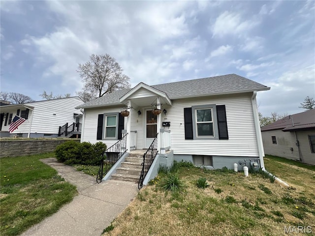 1714 Price St, Hannibal, MO 63401 - bungalow-style house with a shingled roof and a front lawn