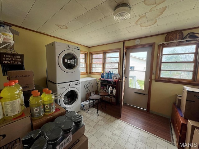 1714 Price St, Hannibal, MO 63401 - washroom with stacked washer / dryer, crown molding, and light tile patterned floors