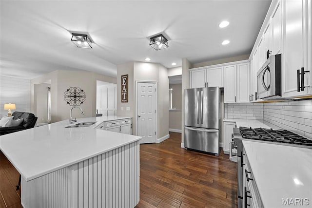 515 Country Chase Dr, Lake St Louis, MO 63367 - kitchen featuring appliances with stainless steel finishes, a sink, light countertops, dark wood-style flooring, and white cabinets