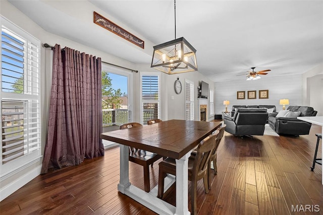 515 Country Chase Dr, Lake St Louis, MO 63367 - dining room with a chandelier, dark wood-type flooring, a ceiling fan, and a fireplace