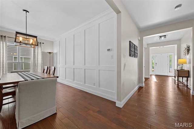515 Country Chase Dr, Lake St Louis, MO 63367 - unfurnished dining area with a decorative wall, dark wood-style flooring, baseboards, a chandelier, and crown molding