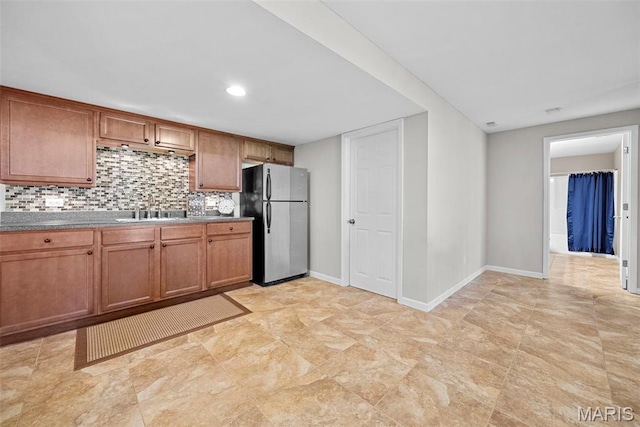 515 Country Chase Dr, Lake St Louis, MO 63367 - kitchen featuring freestanding refrigerator, a sink, brown cabinets, backsplash, and baseboards